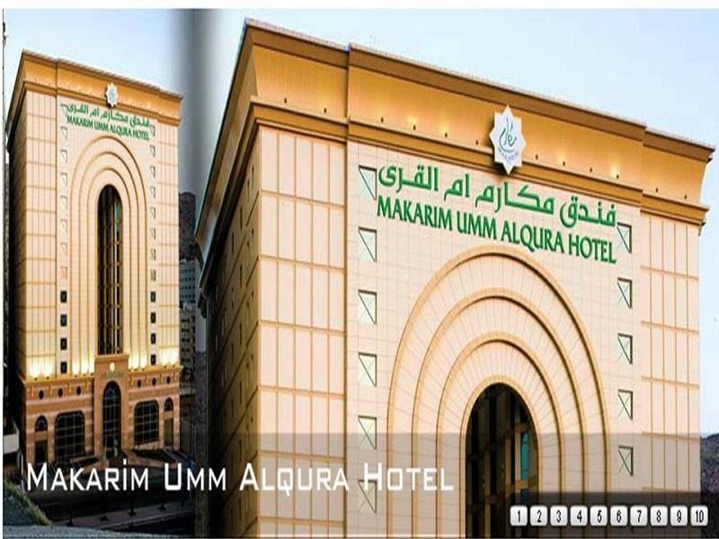 فندق مكارم أم القرى مكة المظهر الخارجي الصورة The image shows the exterior of the Makarim Umm Alqura Hotel, which features a distinctive architectural design. The building has a large, arched entrance and is adorned with a combination of light and darker colored materials. The hotel's name is pr